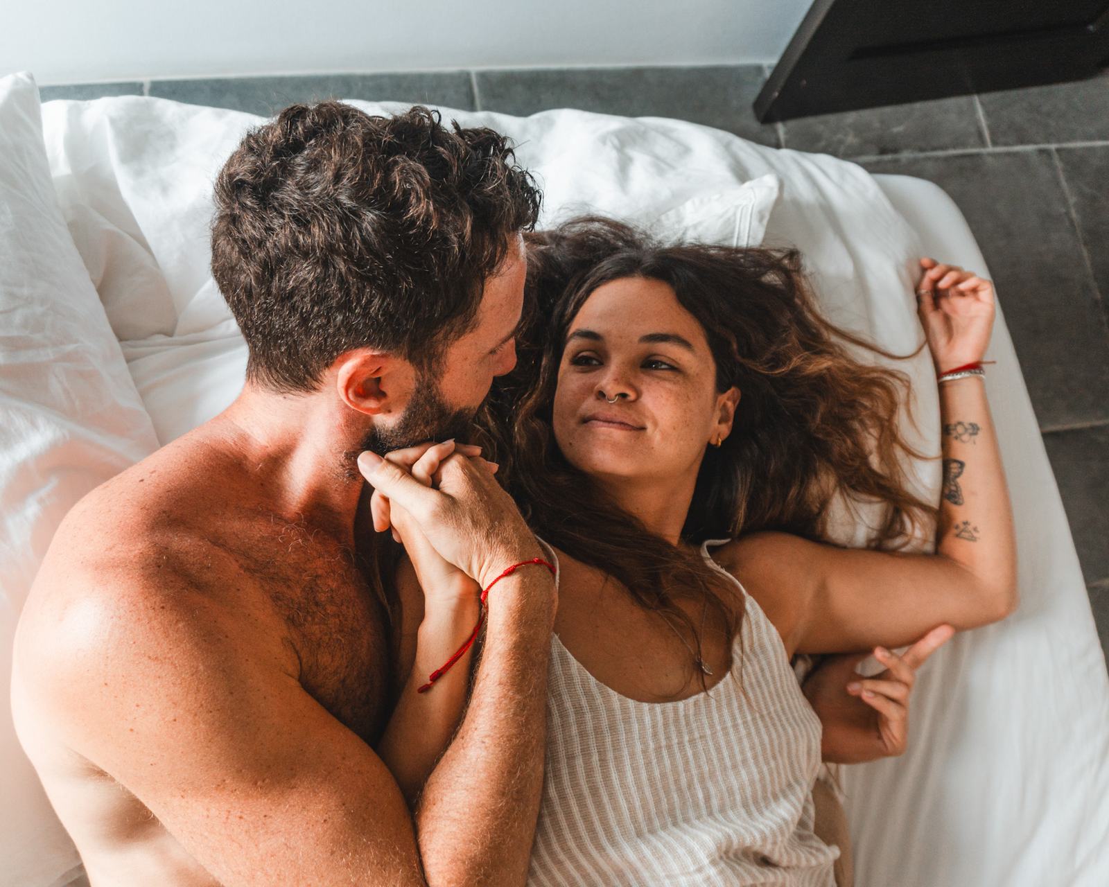 Kyle and his partner, close and relaxed in bed