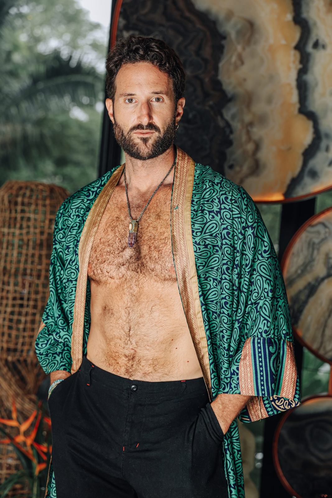 Kyle in a green robe, direct gaze